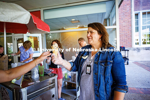 Elizabeth Lorang, the Dean of University Libraries, hands an ice cream to students and staff in hono