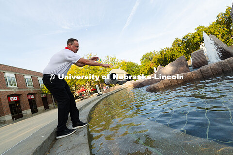 Jon Jenkin, facility manager, tosses a robotic pool skimmer into Broyhill Fountain The device helps 