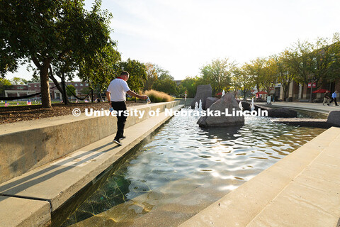 Jon Jenkin, facility manager, adds several packets of pool shock – chemicals that keep algae and b