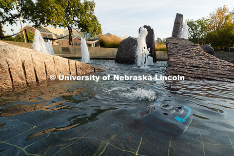 A small robot roves through the water of Broyhill Fountain. Cleaning the fountain used to be time-in