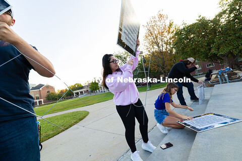 Misha Jalali, ASUN Executive Vice President, fits a sign sharing information about September 11, 200