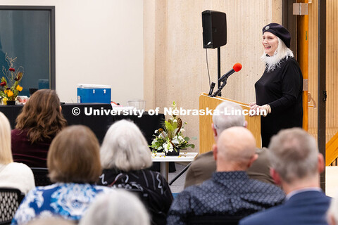 Artist Karen Blessen smiles toward the audience while speaking about her work. The 1973 UNL graduate