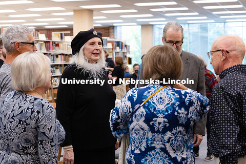 Karen Blessen, in black, speaks with classmates from Columbus High School after a reception celebrat