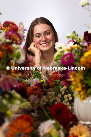 Studio portrait of Laura Albro, Engler Agribusiness Entrepreneur, with cut flowers and arrangements 
