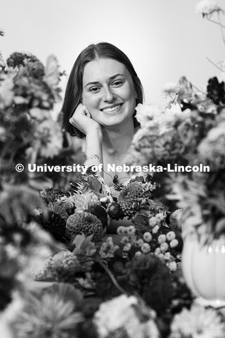 Studio portrait of Laura Albro, Engler Agribusiness Entrepreneur, with cut flowers and arrangements 