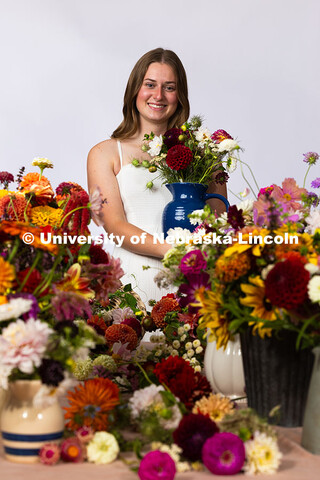 Studio portrait of Laura Albro, Engler Agribusiness Entrepreneur, with cut flowers and arrangements 