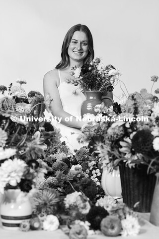 Studio portrait of Laura Albro, Engler Agribusiness Entrepreneur, with cut flowers and arrangements 