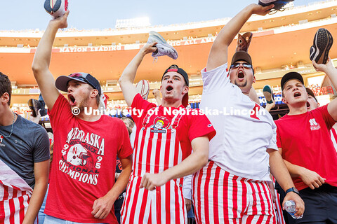 Fans hold up their shoes and cheer at kickoff for the Nebraska vs Akron football game. September 9, 