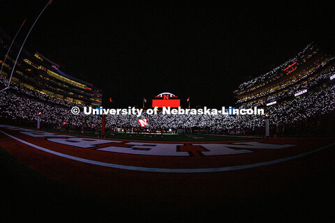 Fans light up the stands with their phones during the 3rd quarter light show at the Nebraska vs Akro