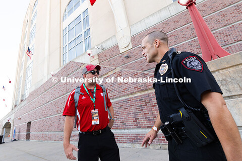 John Backer, University Police Captain, chats with Adam Bierhaus, a Husker fan from Cairo, NE., befo