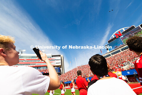 Two young Husker fans watch the flyover from the northeast sidelines before the game. Nebraska footb