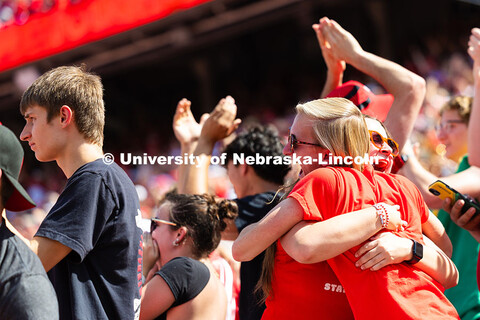 First-year students Carter Neubert and Emmy Shanahan hug after the Huskers score a touchdown in the 