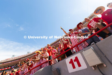 A student points with a corn-glove clad hand during the game against Houston Christian University. N