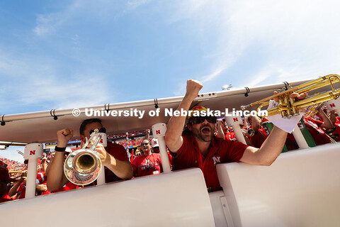 Band alumni Seth Kurfman (right) and Spencer Collins yell "Go Big Red" after the fight song. They jo