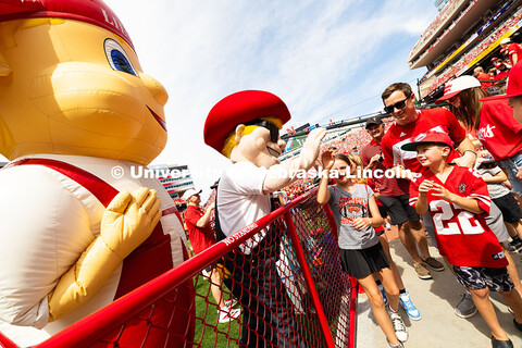 Herbie and Lil' Red give high-fives to fans of all ages during halftime. Nebraska football vs. Houst