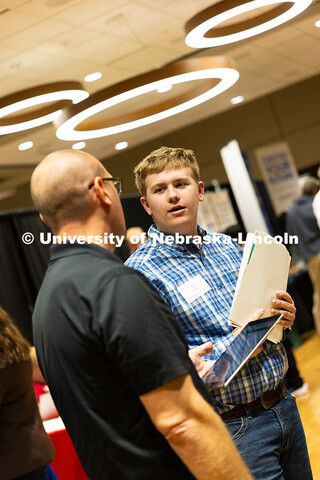 Dylan Smith, a first-year student studying ag economics, speaks with Jeff Ehrhardt, who received his