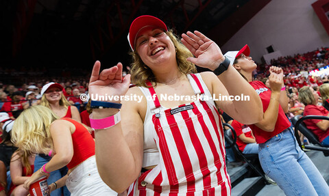 Sophie Rohlfing, a junior studying forensic science, dances in her striped bib overalls with friends
