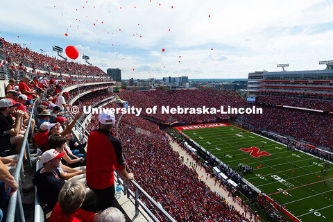 Balloons are released after the Huskers score their first touchdown in the game against the Universi