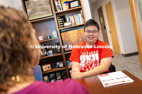 Huy Le, a senior in the Honors Program studying agricultural economics, speaks with Rebecca Baskervi