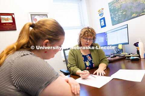 Joann Ross, Honors Program faculty fellow, discusses a syllabus with Kathryn Koehler, a junior in th