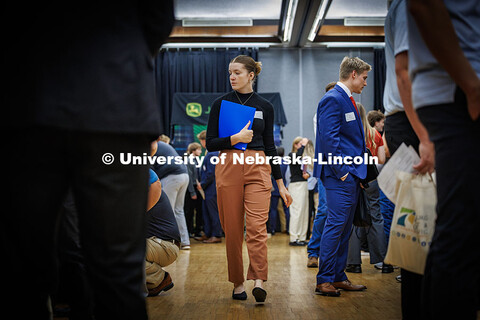 Senior, Samantha Kluthe, walks through a busy aisle full of students and recruiters during the City 