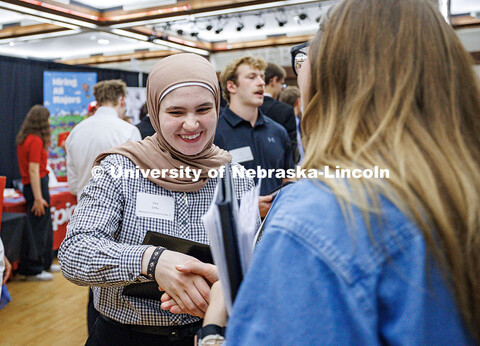 Junior mechanical engineering major, Sara Salha, shakes hands with a recruiter during the City Campu