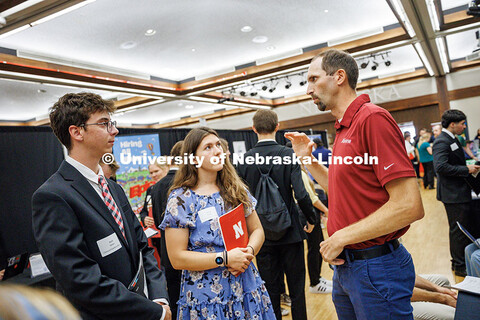 Wyatt Nelson (left to right) and Alanna Snyder, both from the College of Engineering, chat with a re