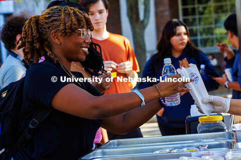 A student grabs a free churro from Papi Churros during the Fiesta on the Green. Fiesta on the Green 