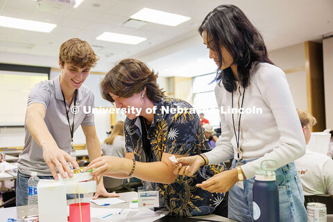 Gannett Bishop, from left, Analise Erlbacher, and Riya Pawar work to build their vitamin dispenser i