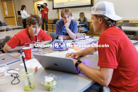 Pierce Allison, from left, Slade Reese, and Nikolay Sysoev discuss their project inside Howard L. Ha