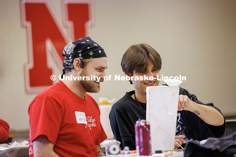 Fischer White, left, and Shane Daughtrey test their vitamin dispenser inside Howard L. Hawks Hall. 2