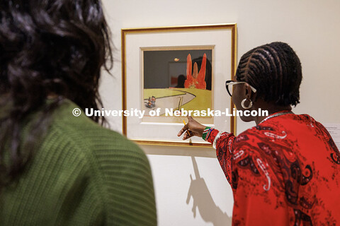 A student points to a work of art. Students in the Music for Non-Majors 171: Arts Alive at Nebraska 