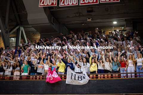 Members of Pi Beta Phi raise their phone flashlights and cheer during the Showtime performances in t
