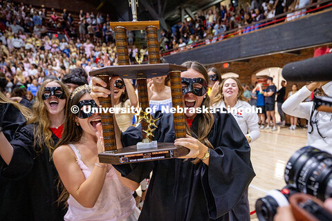 Mortarboard holds up the first-place trophy after winning showtime for their category. Recognized St