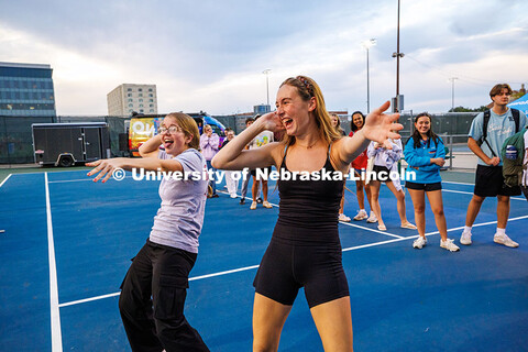 Maureen Kubicek (left) and Kaitlyn Schmit dance at the Owala College Pickleball Tour pop-up. The stu