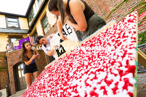 Kappa Delta members Maddie Balus, Jordan Tipton and Ella Reifenrath glue pom-poms made from party na