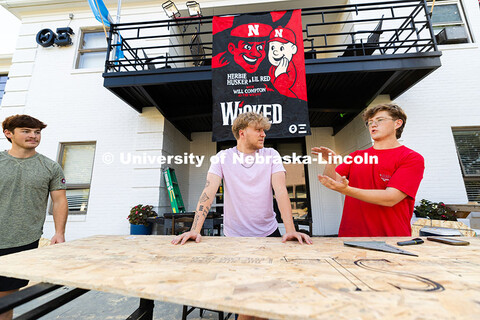 Alex Bjorman (right) explains the plan for building the Theta Xi and Alpha Phi yard display to Zach 