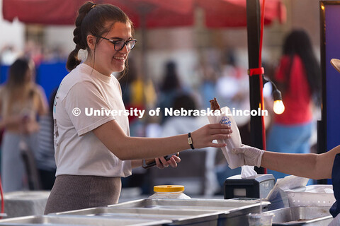 Lucy Salyer, a junior, gets a churro from Papi Churros during the first Homecoming Yard Show, hosted