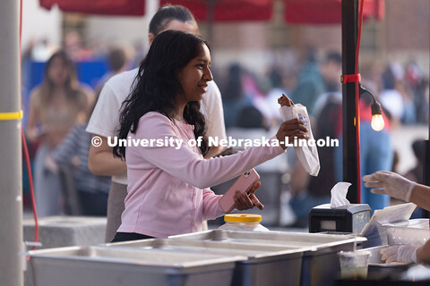 First-year student Sandarika Warjri picks up a churro from Papi Churros with a friend during the fir