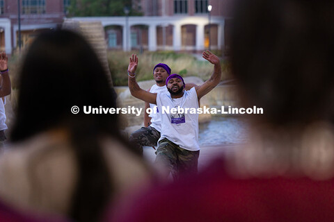 Members of the Omega Psi Phi fraternity step and chant in front of the Nebraska Union during the fir