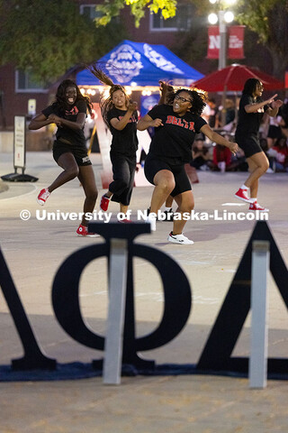 Members of the Delta Sigma Theta sorority chant, sing and dance in front of the Nebraska Union for t