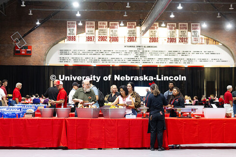 Staff and faculty celebrating employment anniversaries get barbecue sandwiches, chips and treats fro