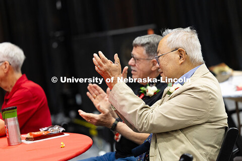 Bing Chen and Donald Puckett clap for fellow long-time UNL employees. Puckett was recognized for ser