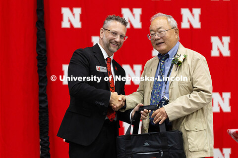 Bing Chen shakes hands with Ben Lennander during the Celebration of Service. Chen was recognized for