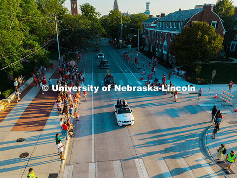 Aerial view of Husker students and community members watching the Homecoming Court drive down 16th s