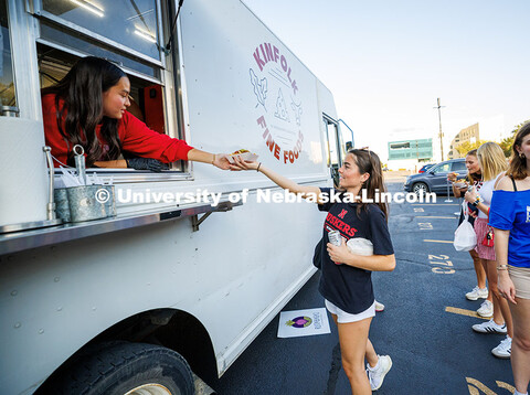 Sophomore, Maddie Ashelford, receives her food at a food truck during the Cornstock Festival for Hom