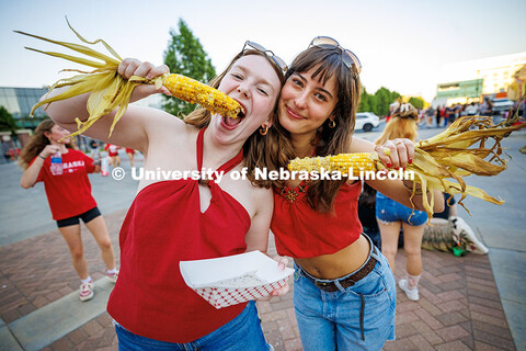 Emma Gross (left) and Cassidy Srery pose with their corn during the Cornstock Festival. Homecoming p