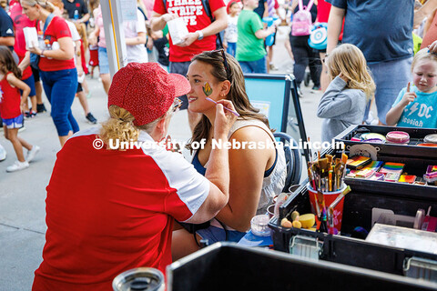 Hayden Hudson, a junior Broadcasting and Journalism major, gets a corn cob painted on her face at th