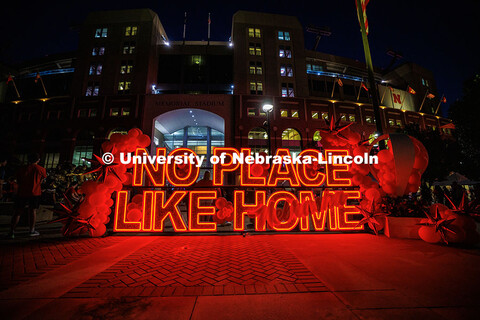 No Place Like Home sign in front of Memorial Stadium during the Cornstock Festival for Homecoming 20