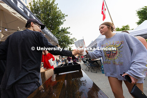 Elle Malleck grabs a bag of kettle corn during Cornstock. Malleck is a first-year student studying b